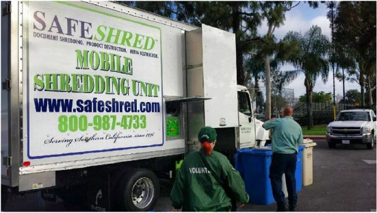 safeshred shredding truck driver emptying documents into shredder
